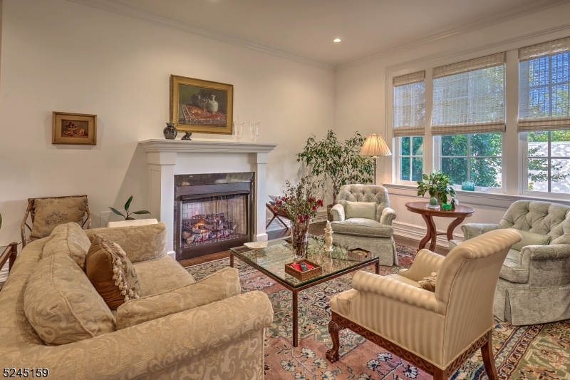 a living room with furniture a large window and a fireplace