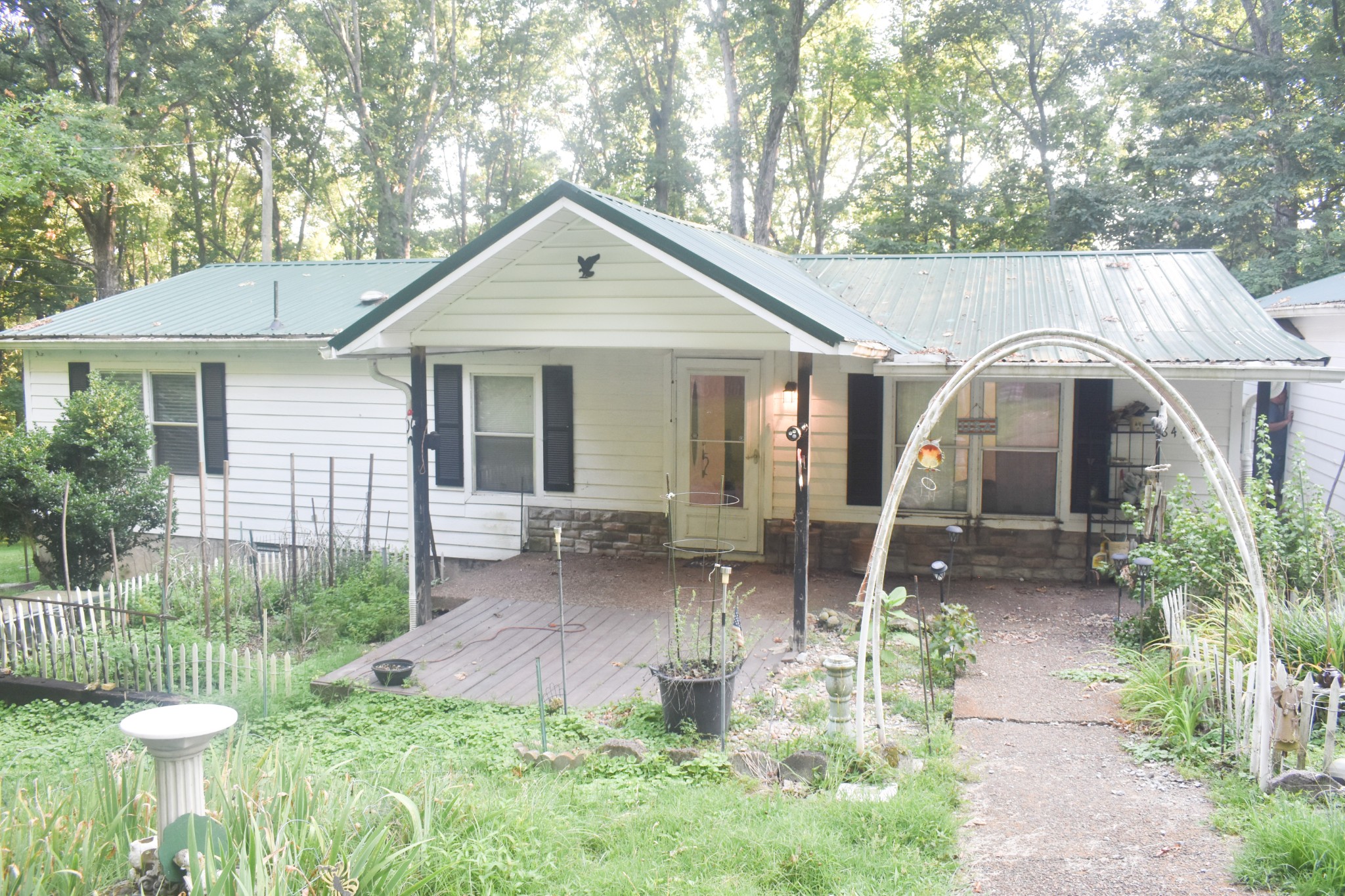 a front view of a house with a yard and seating space