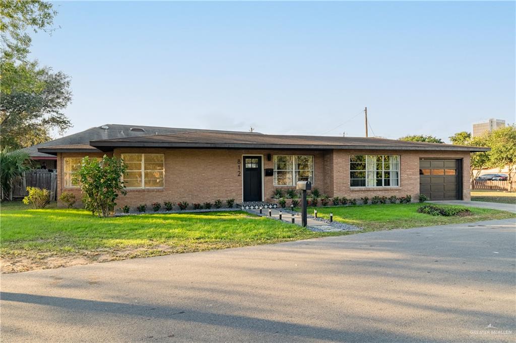 View of front of home featuring a garage and a front lawn