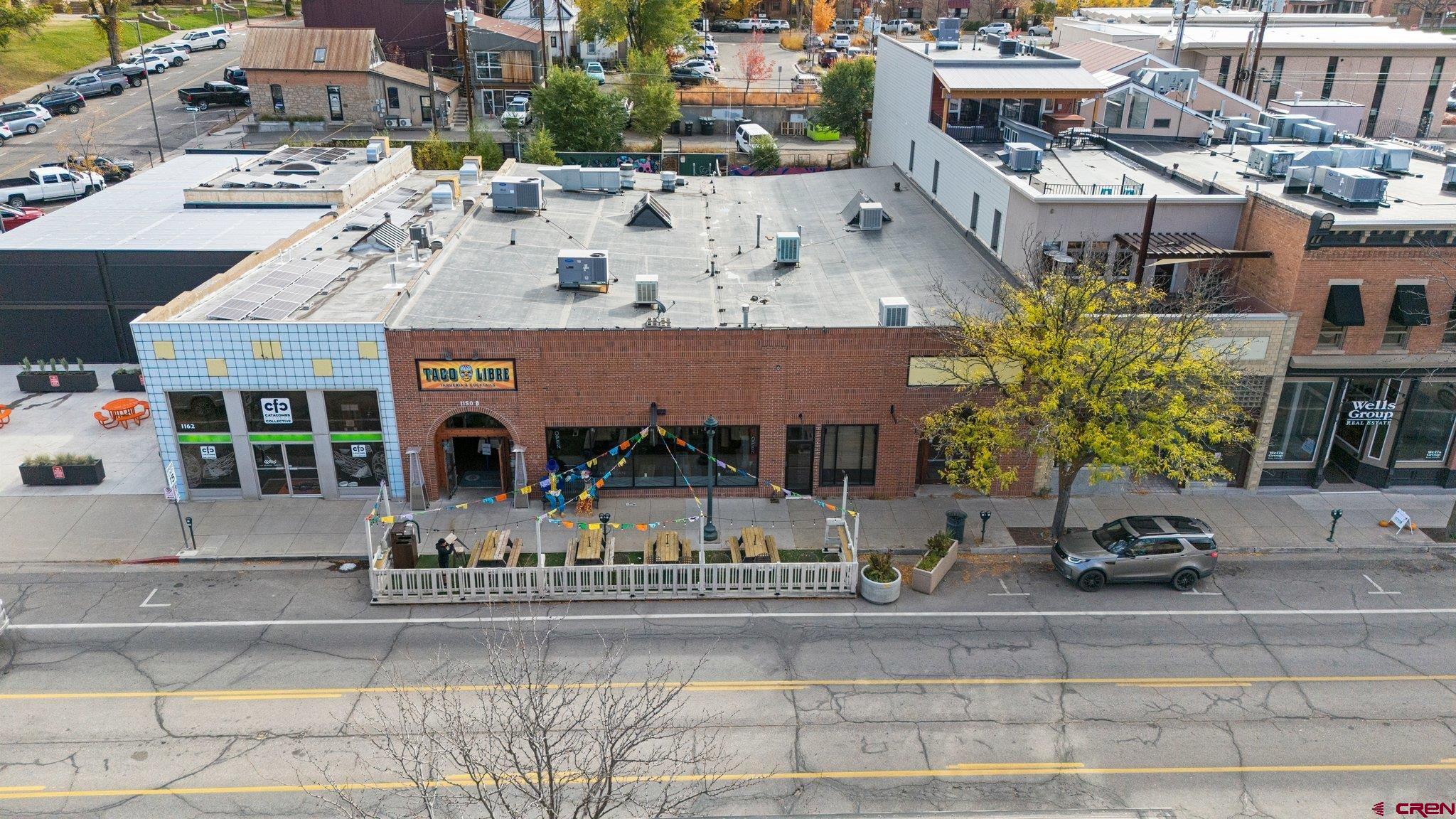 a view of a building with cars parked