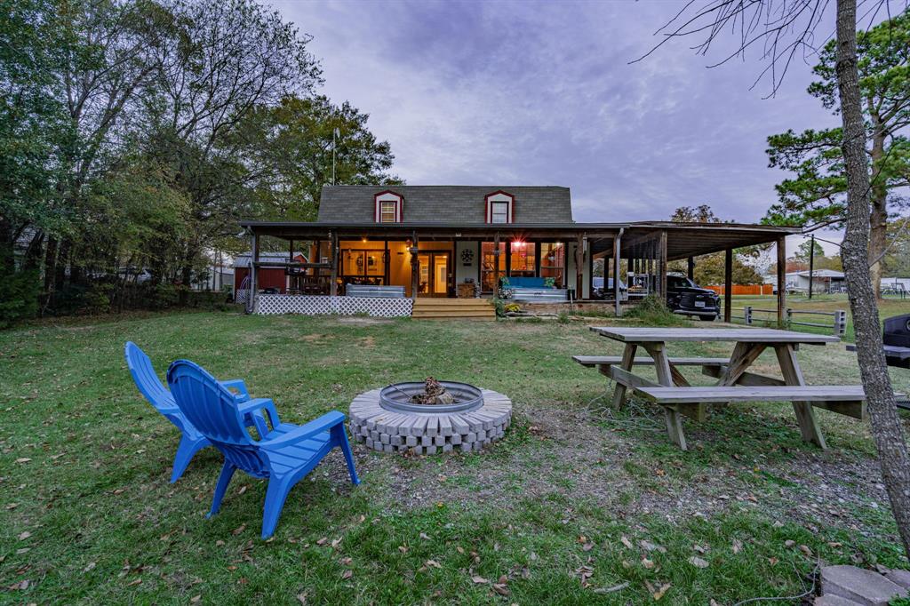 a view of a house with backyard porch and sitting area