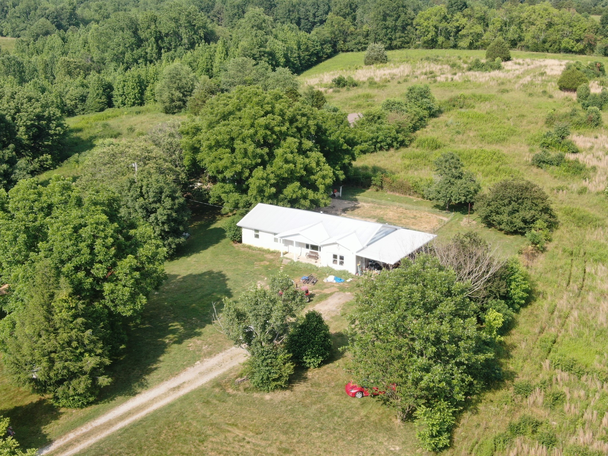 an aerial view of residential house with green space