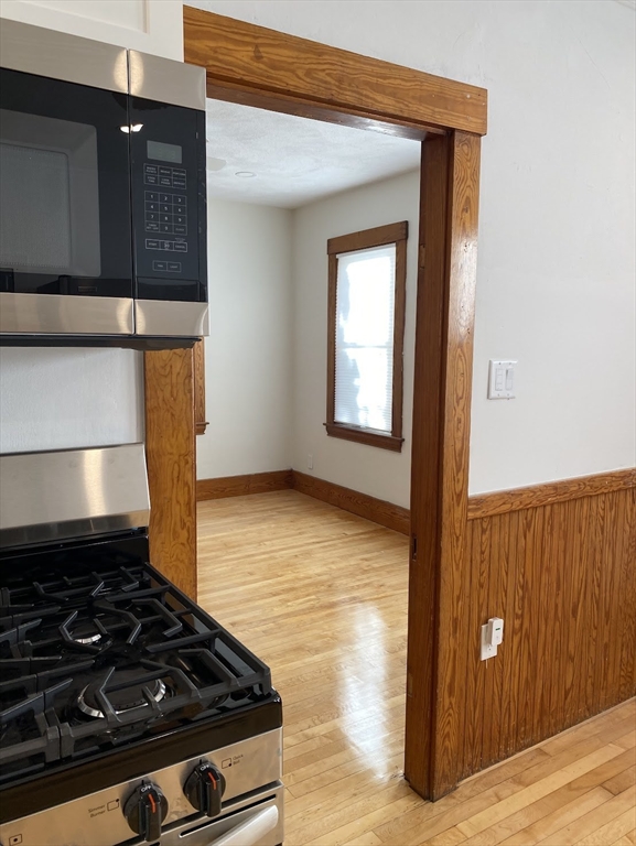 a stove top oven sitting inside of a kitchen