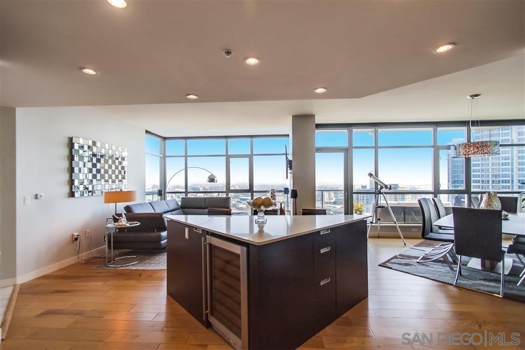 a kitchen with stainless steel appliances kitchen island granite countertop a sink and a refrigerator