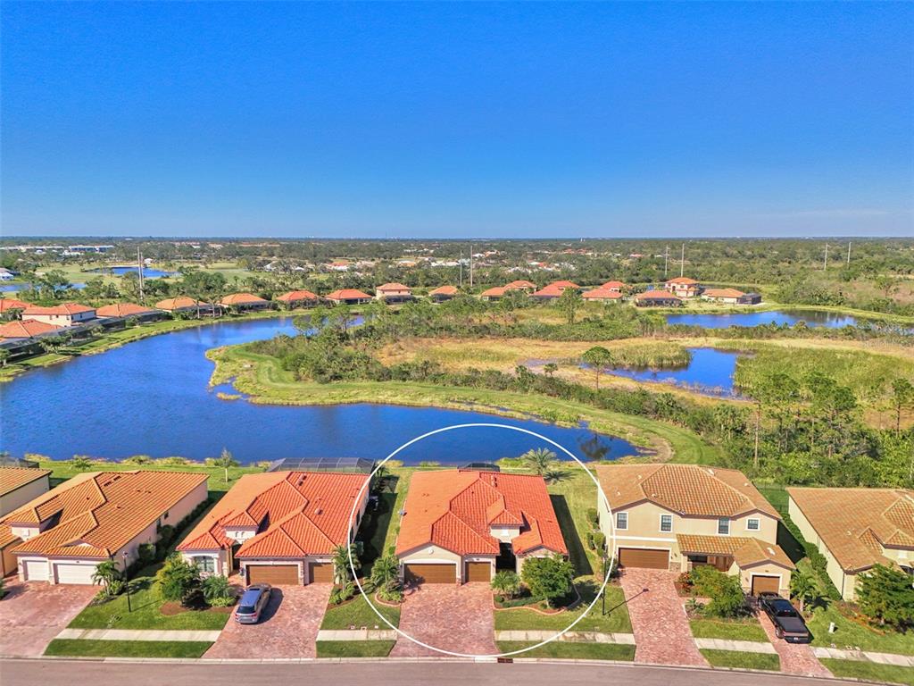 an aerial view of residential houses with outdoor space