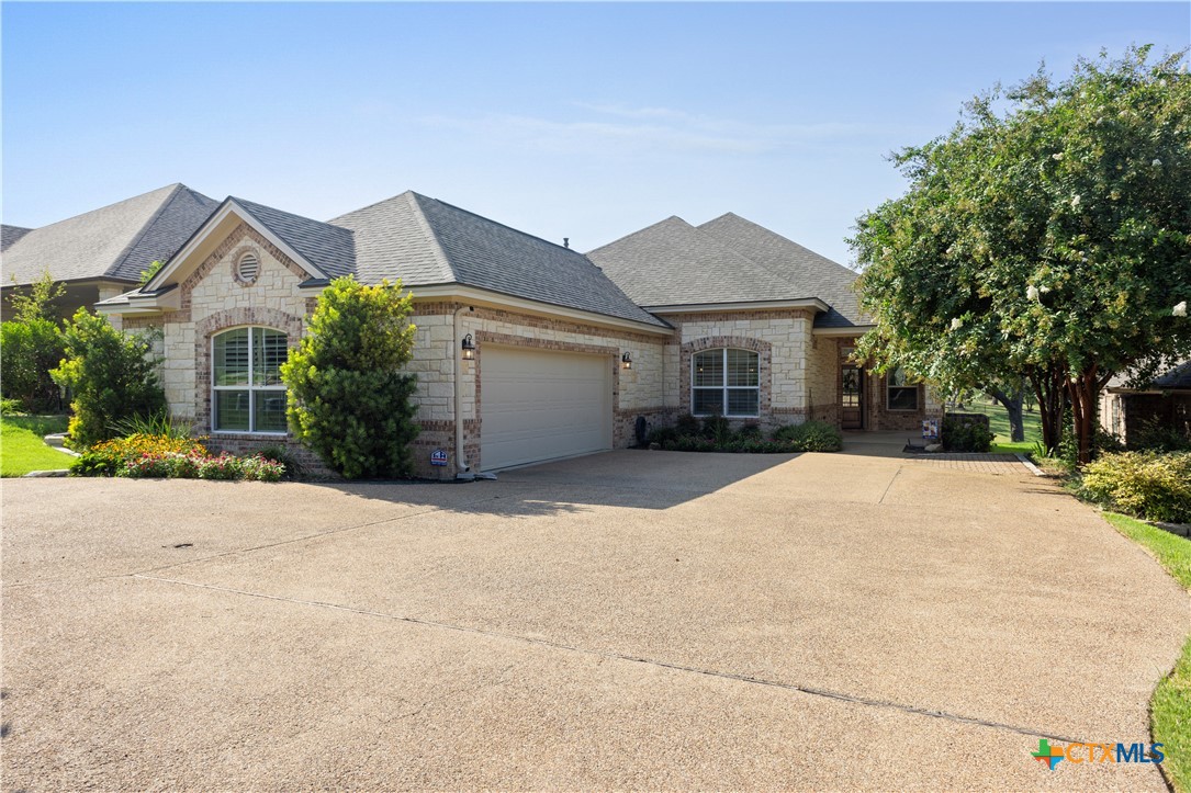 a front view of a house with a yard and a garage