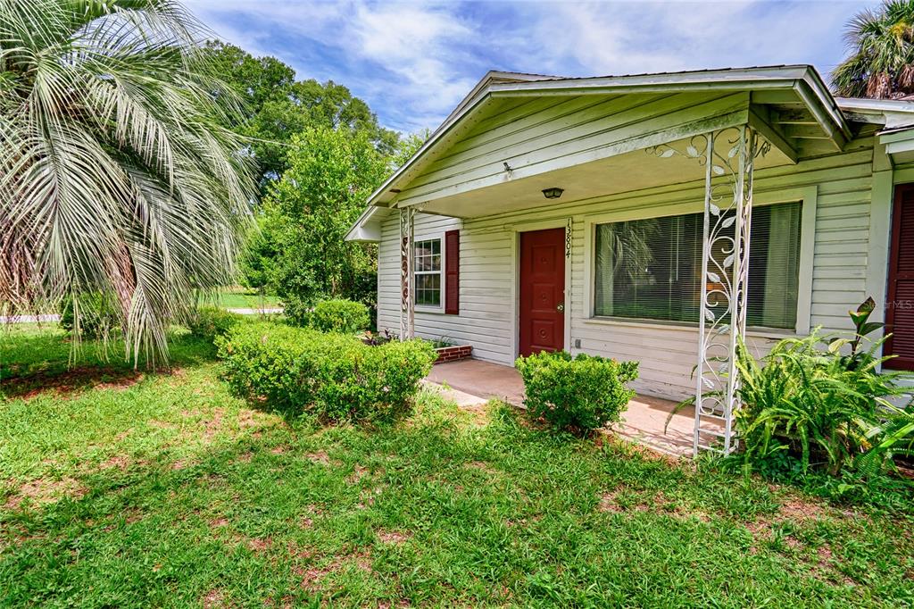 a view of a house with a small yard and plants