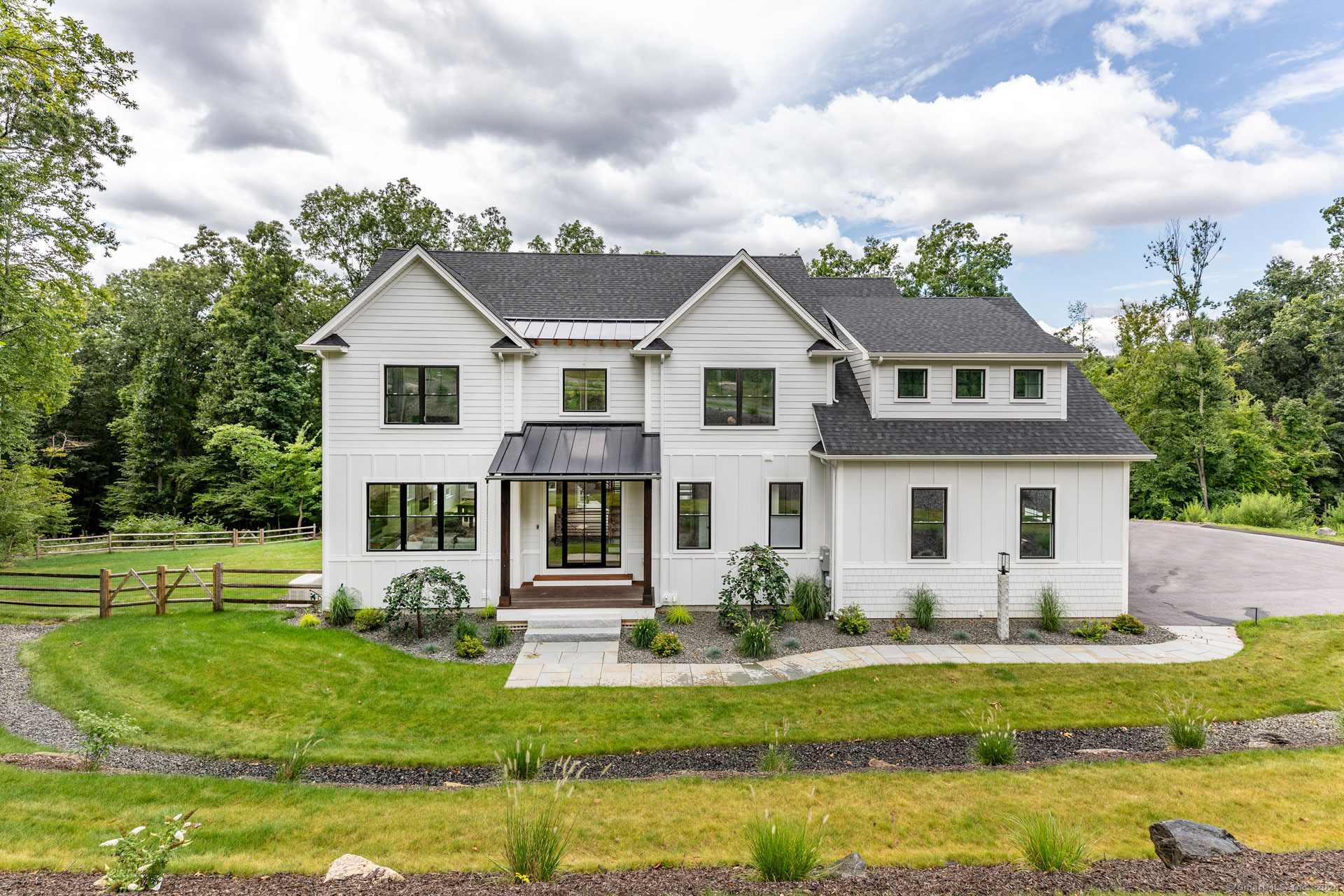 a front view of house with yard and green space