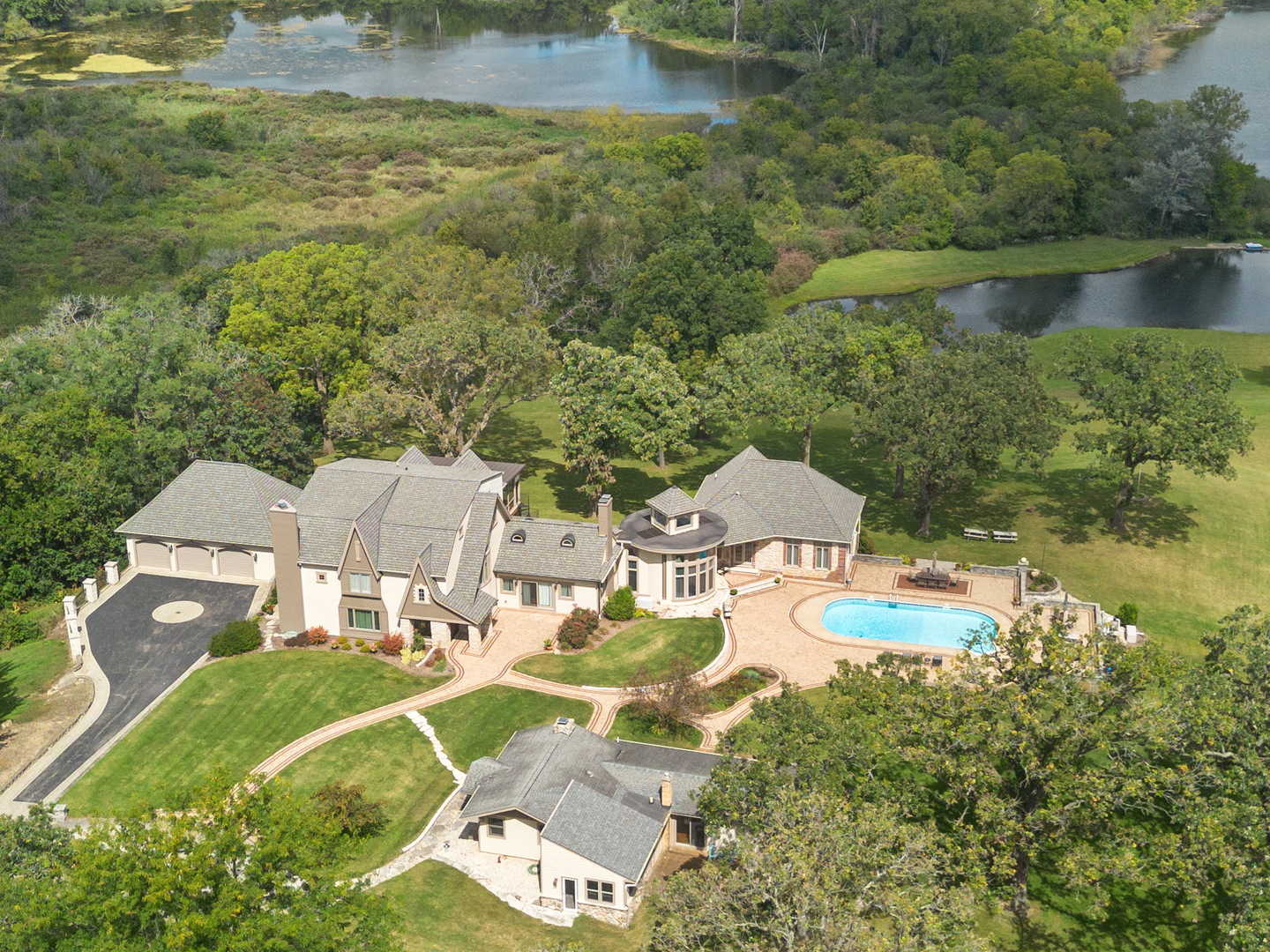 an aerial view of a house with lake view