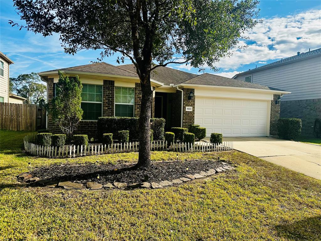 a front view of a house with a garden and patio