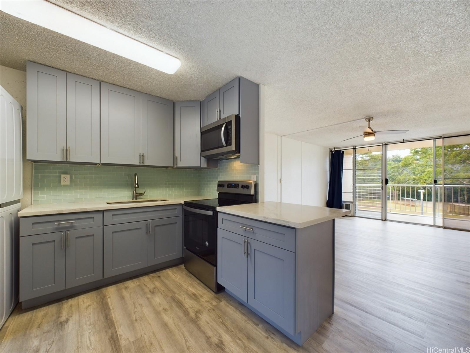 a kitchen with stainless steel appliances granite countertop a stove and cabinets