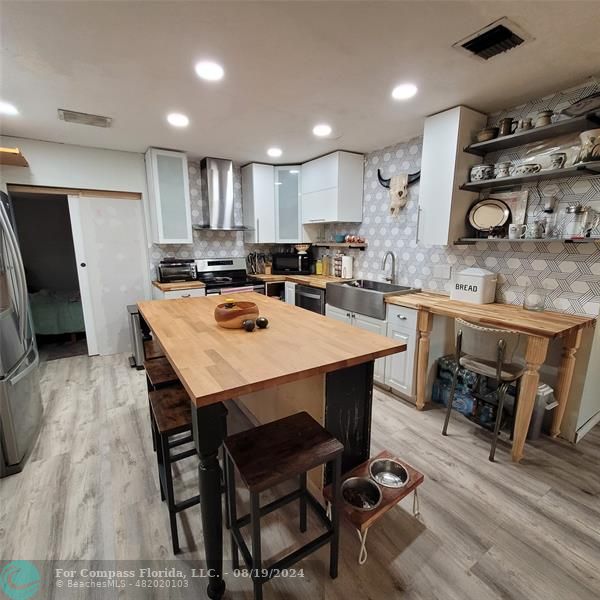 a kitchen with a table chairs stove and microwave