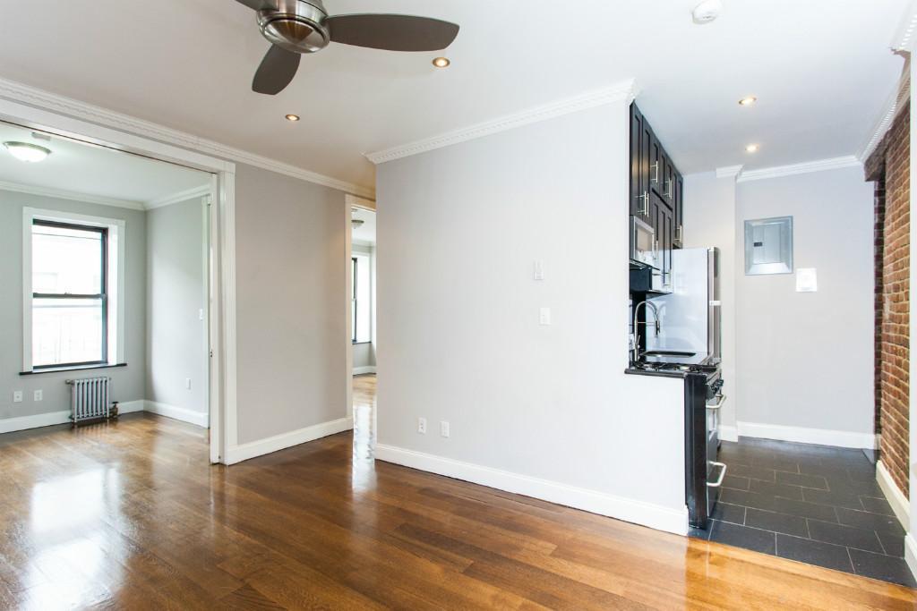 a view of empty room with wooden floor and window