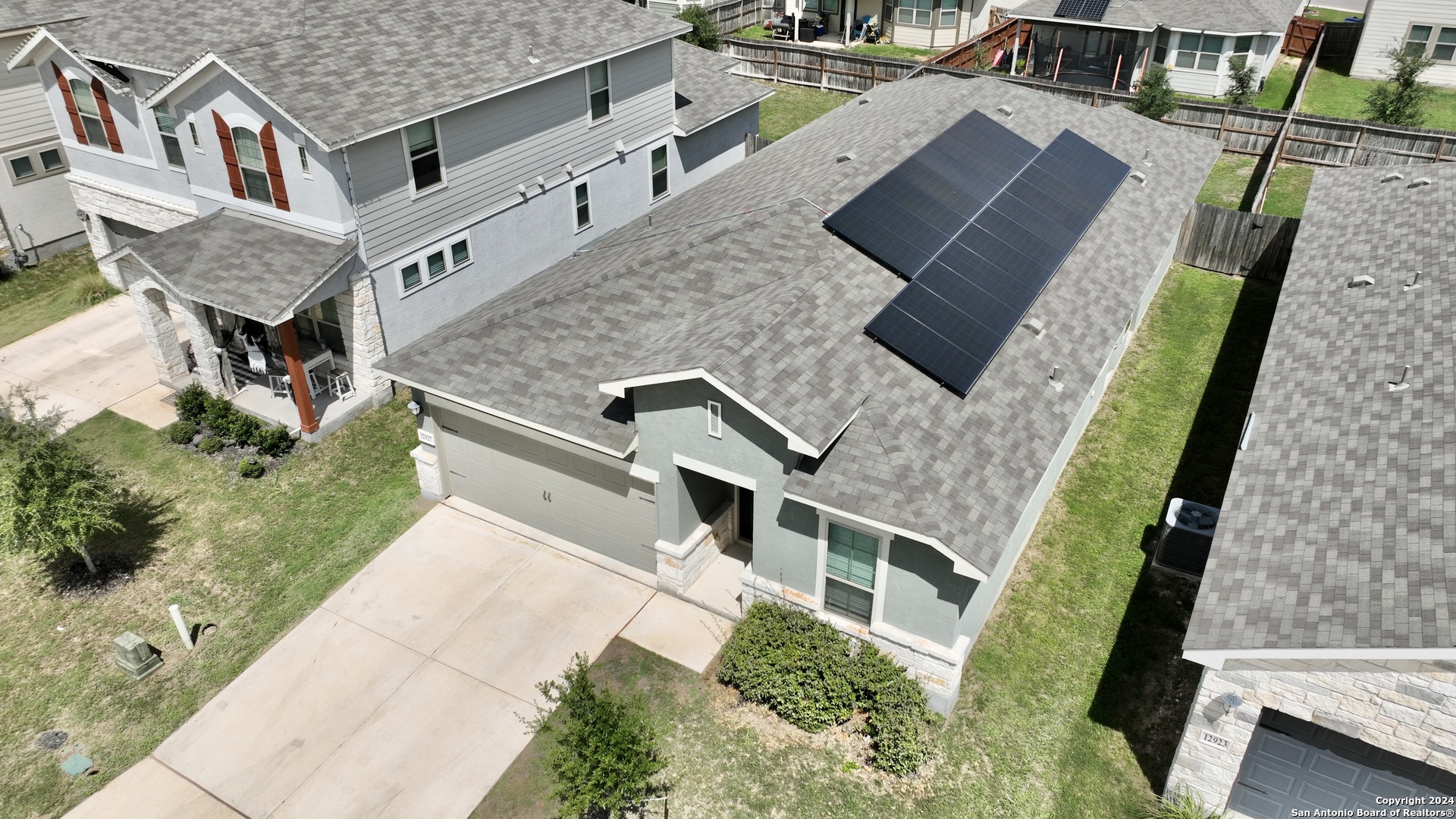 an aerial view of residential houses with outdoor space