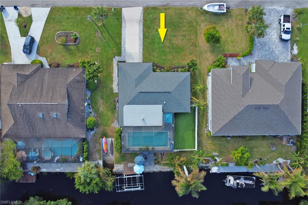 an aerial view of a house with a garden and a yard