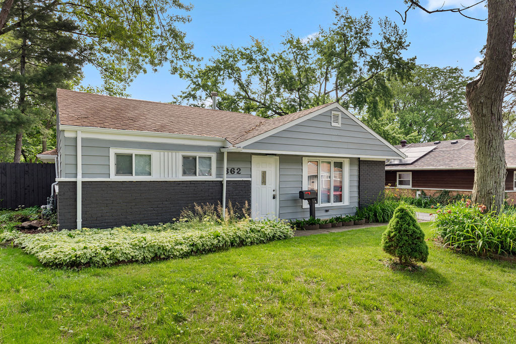 a front view of a house with garden