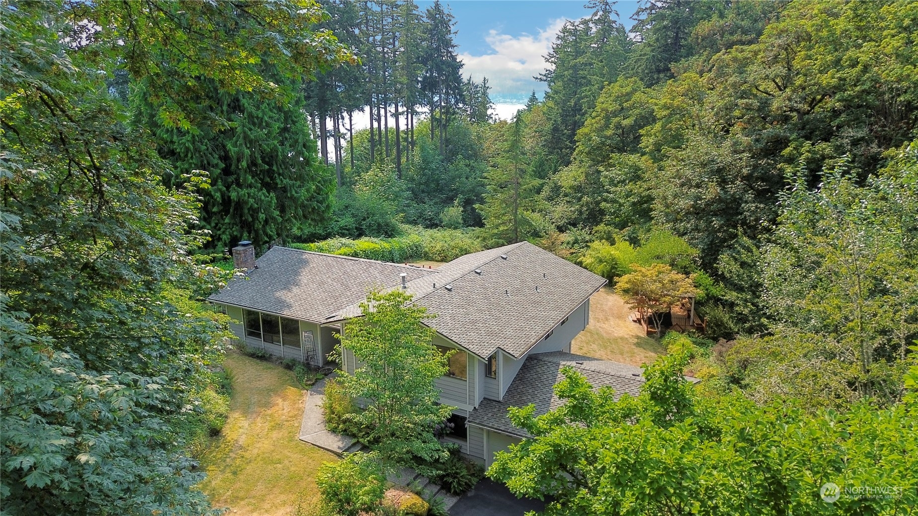 an aerial view of a house with yard swimming pool and outdoor seating