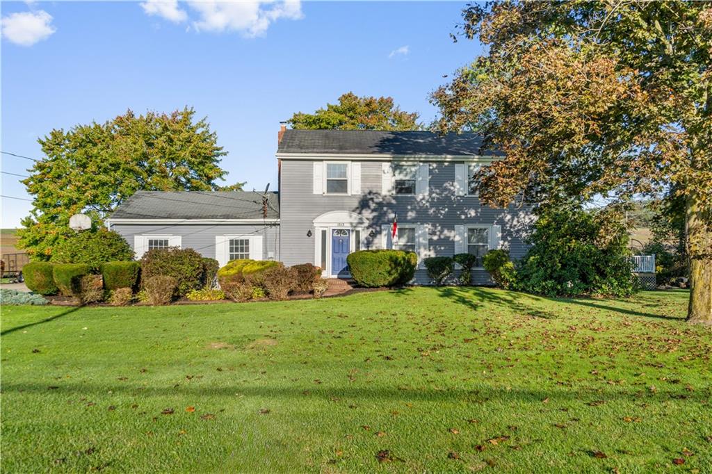 a front view of house with yard and green space