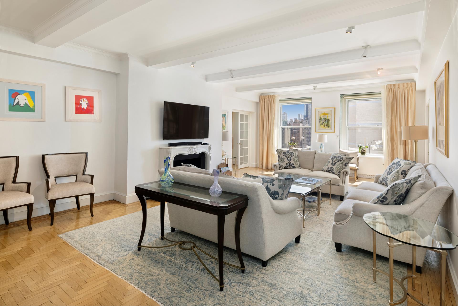 a living room with furniture wooden floor and a flat screen tv