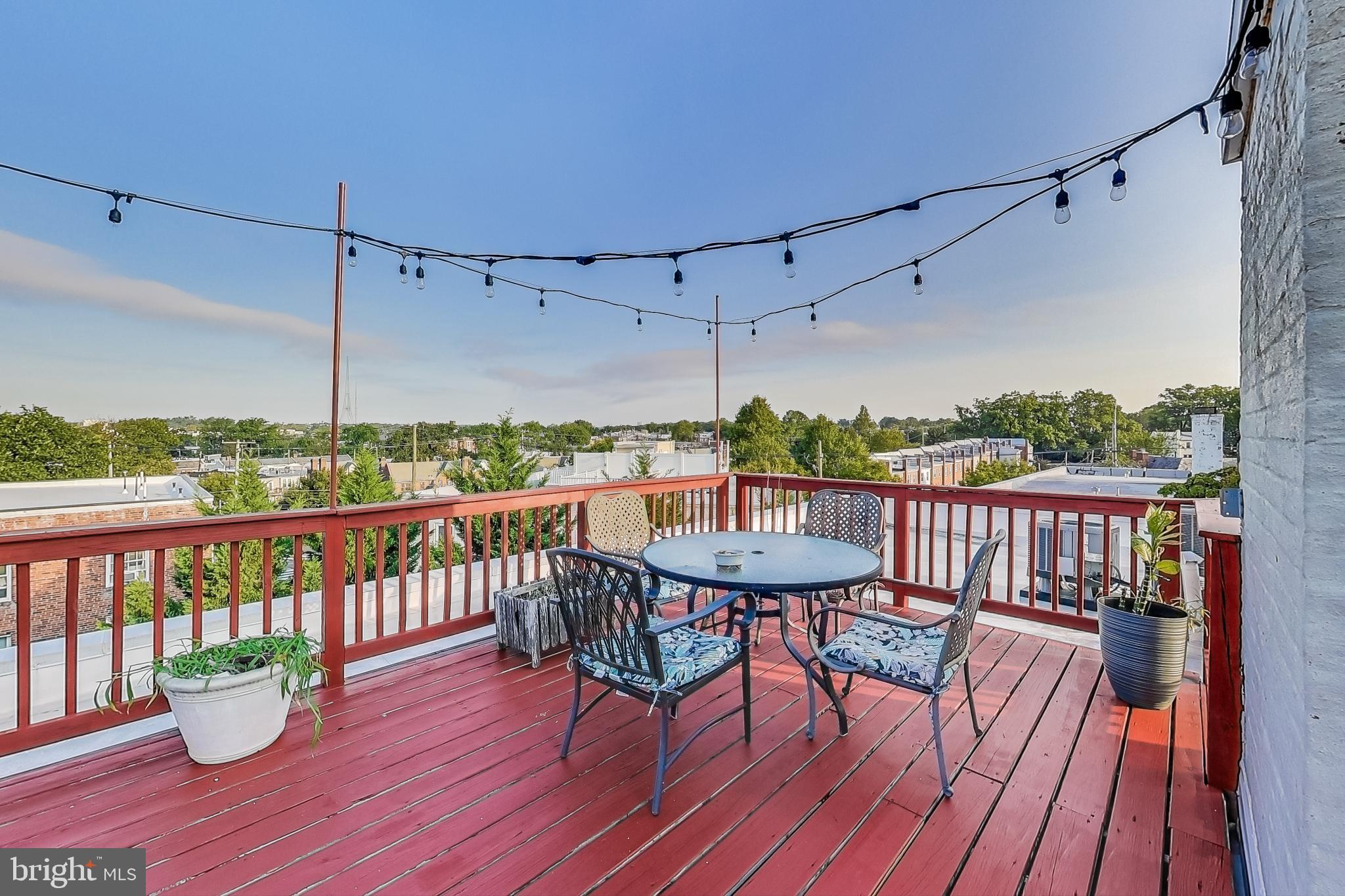 a view of a balcony with furniture and wooden floor