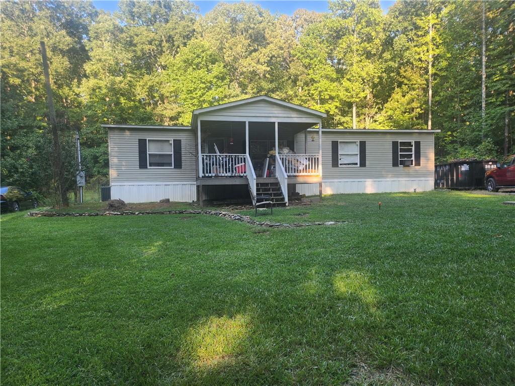 a front view of a house with a yard and trees