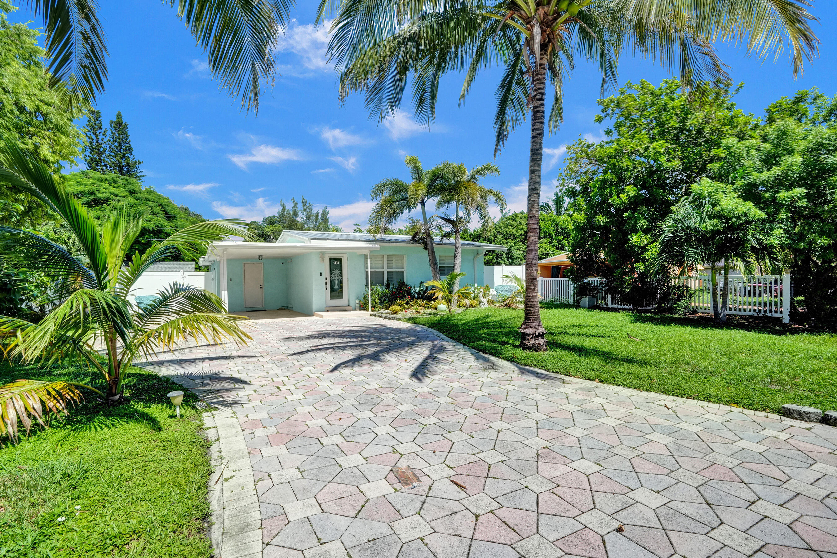 a house with palm tree in front of it