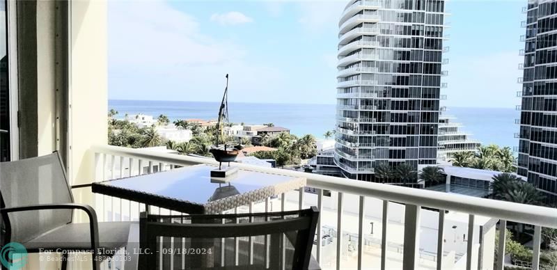 a view of a balcony with a table and chairs