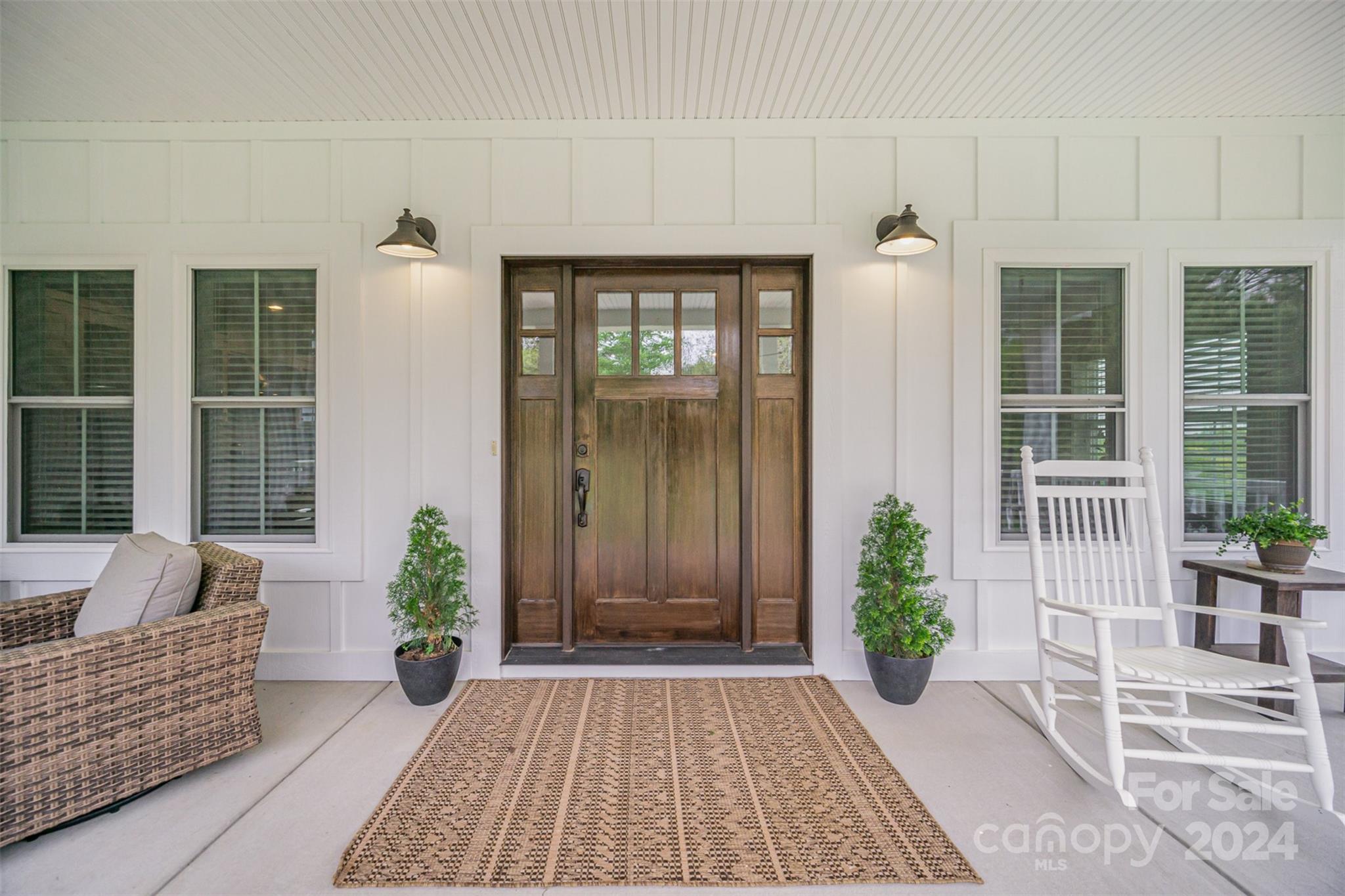 a front view of a house with outdoor seating