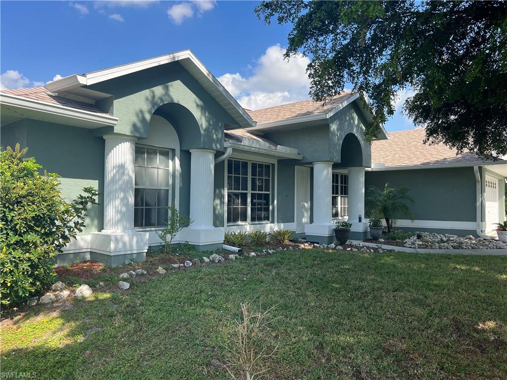 View of front of property with a front yard