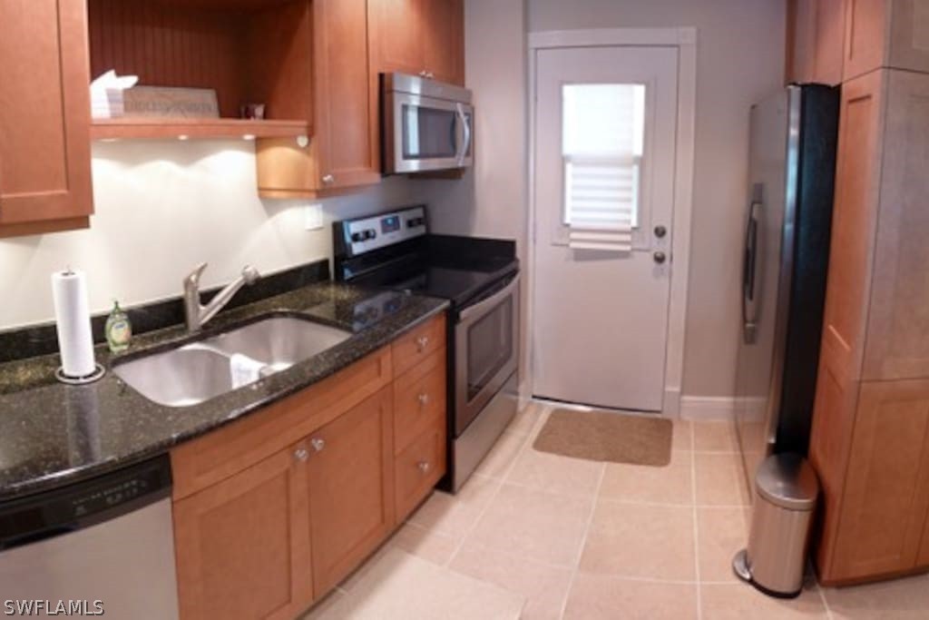 a kitchen with granite countertop a sink and a stove