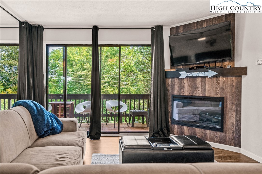 a living room with fireplace furniture and a flat screen tv