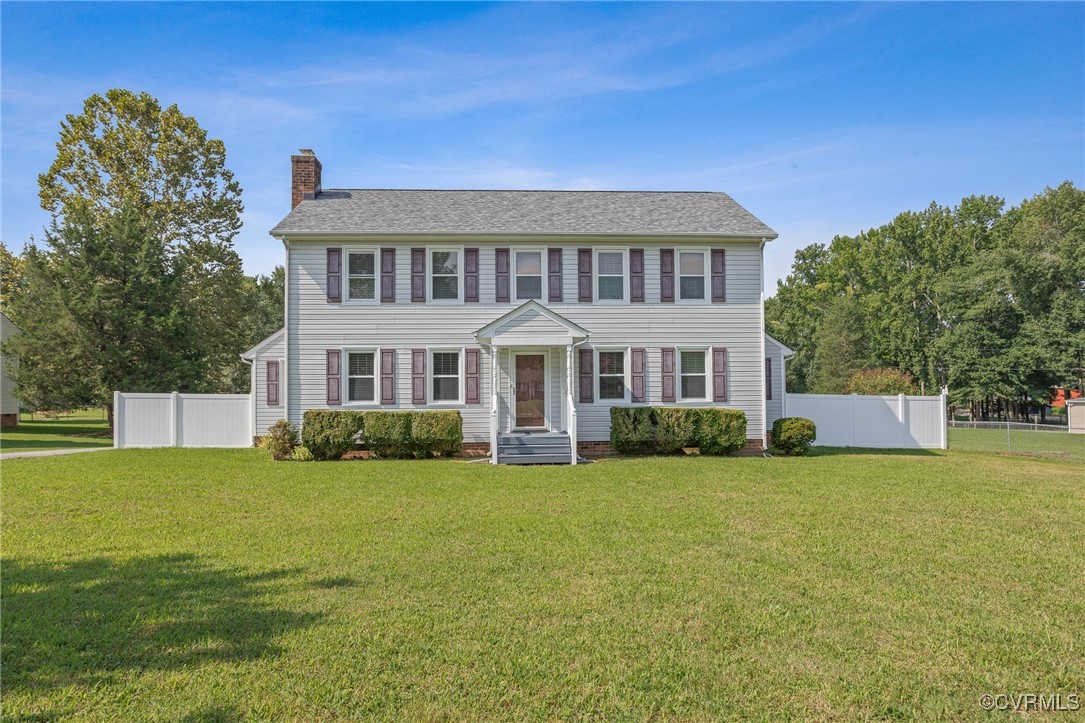 a view of a house with a yard and sitting area