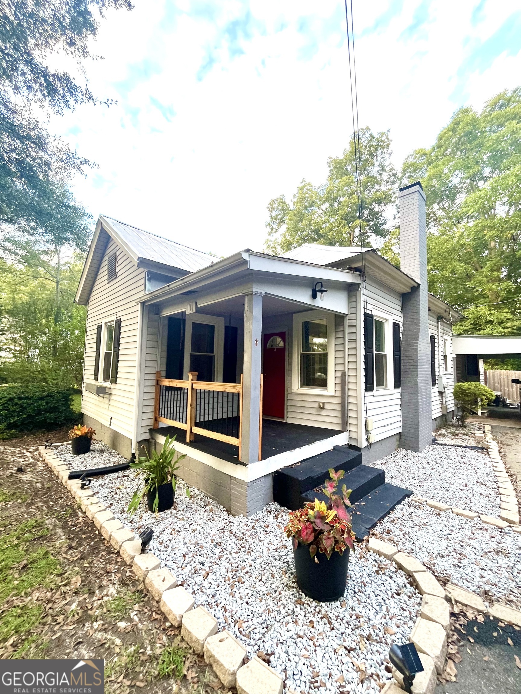 a front view of a house with a lounge chair