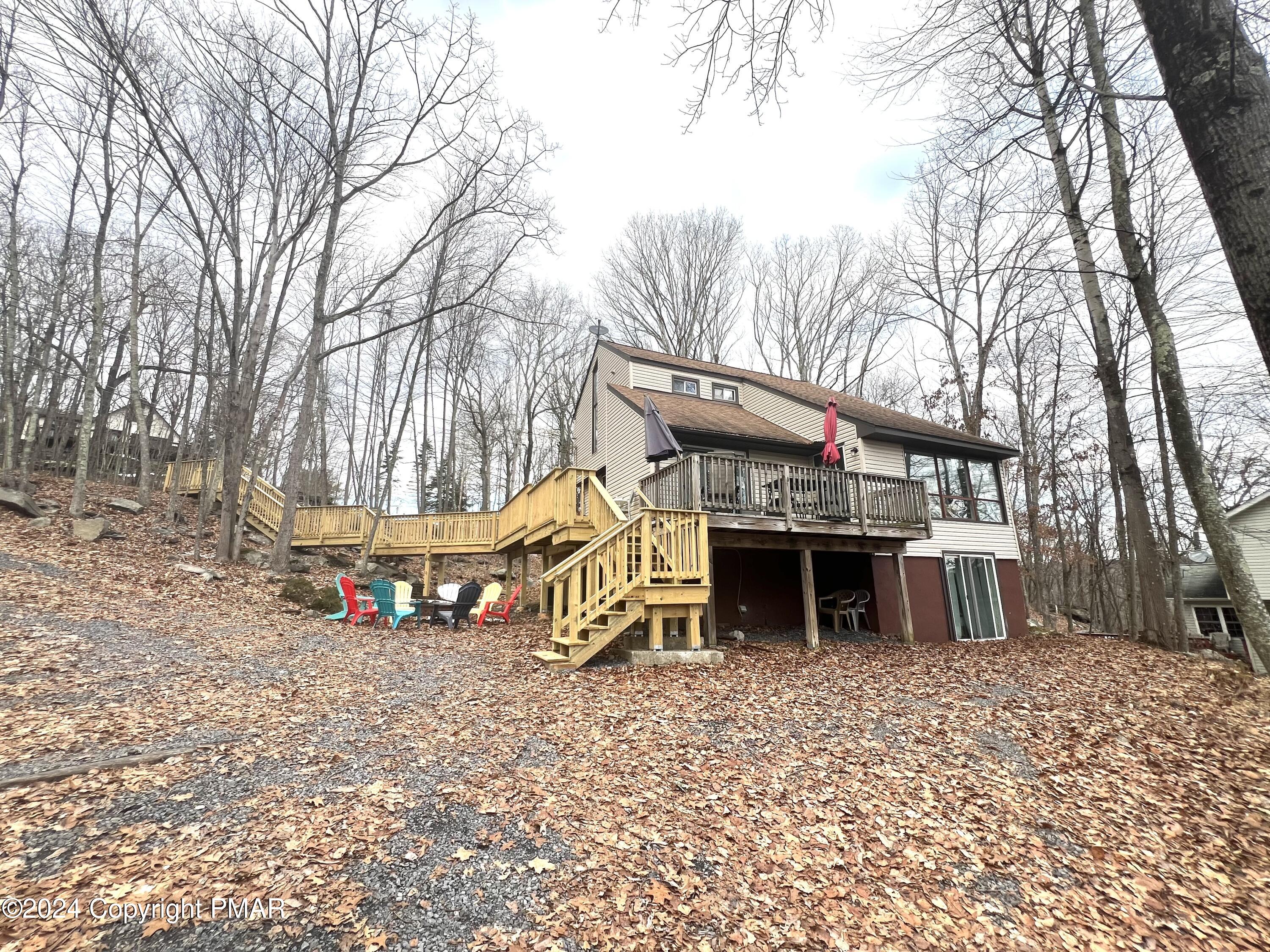 a view of a house with a yard and sitting area