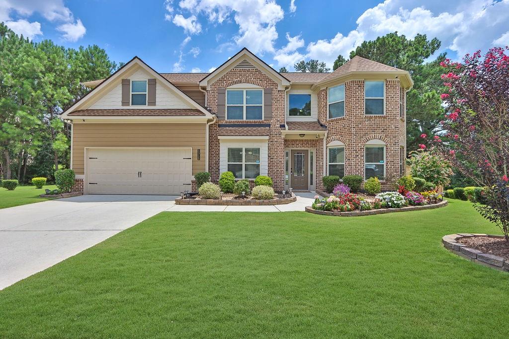 a front view of house with yard and green space