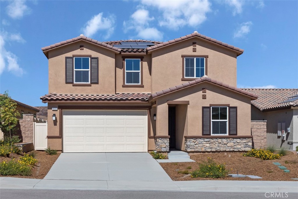 a front view of a house with a yard and garage