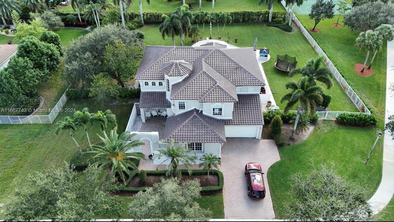 an aerial view of a house with a garden and plants