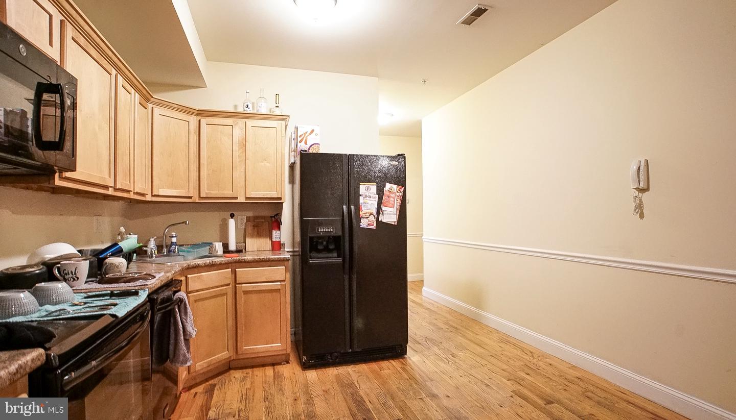 a kitchen with stainless steel appliances granite countertop a refrigerator and a sink