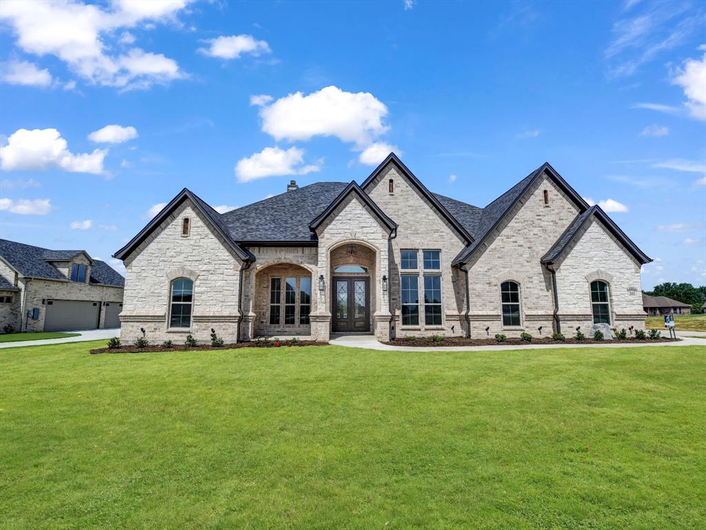 a view of a house with a big yard and large trees