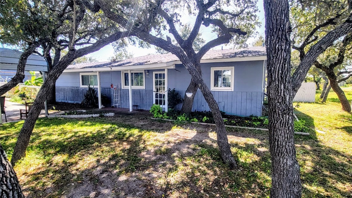 a front view of house with yard and green space