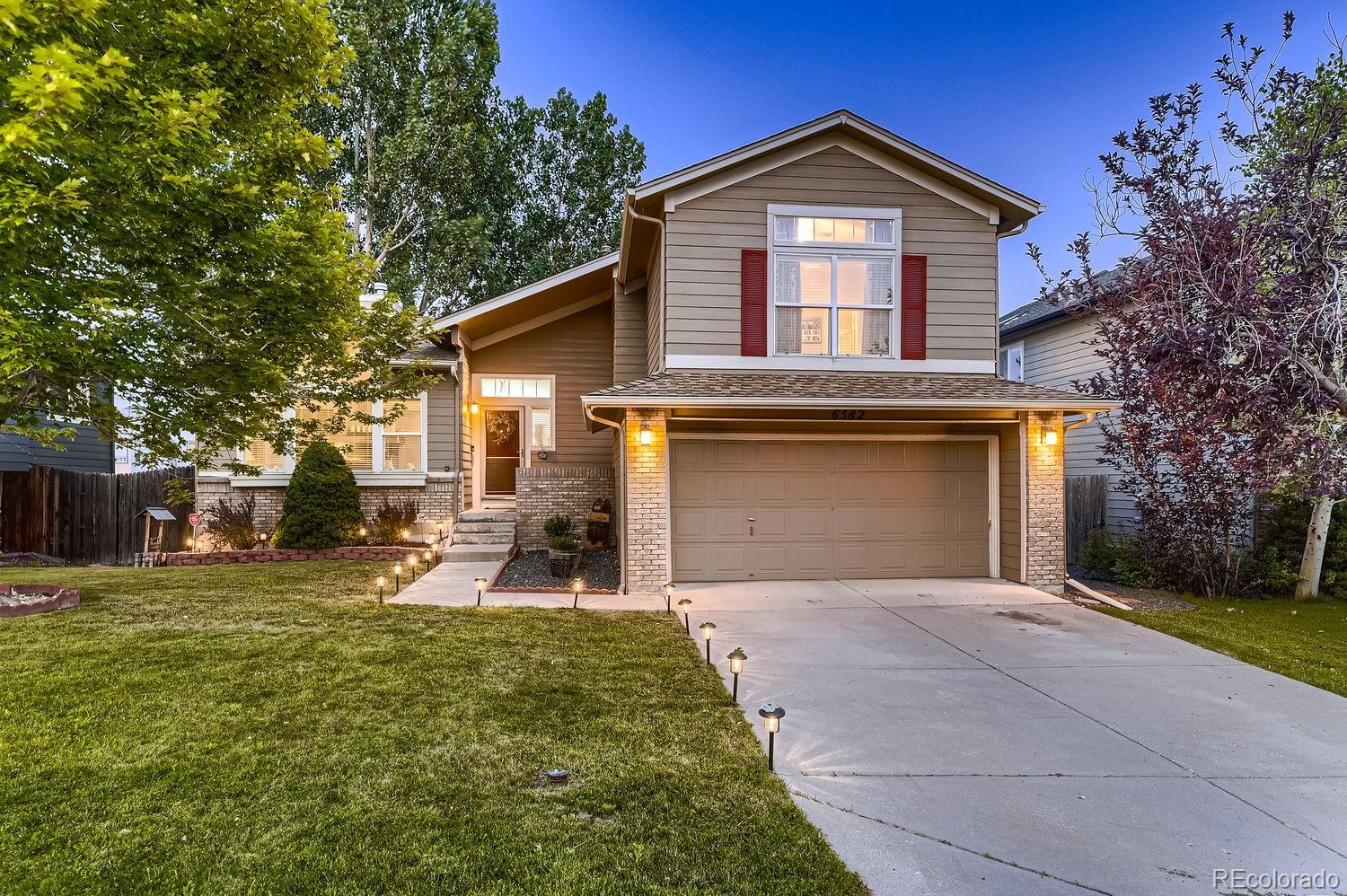 a front view of a house with a yard and garage