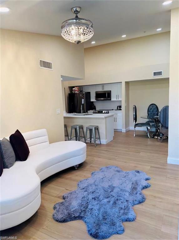 a living room with furniture and a chandelier