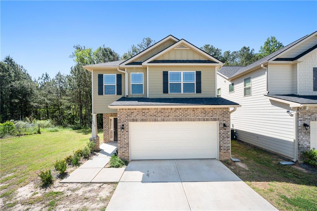 a front view of a house with a yard and garage