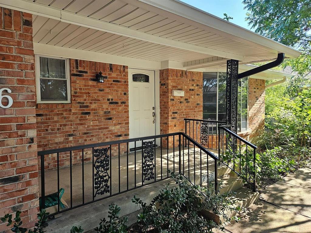 a view of a house with a wooden deck