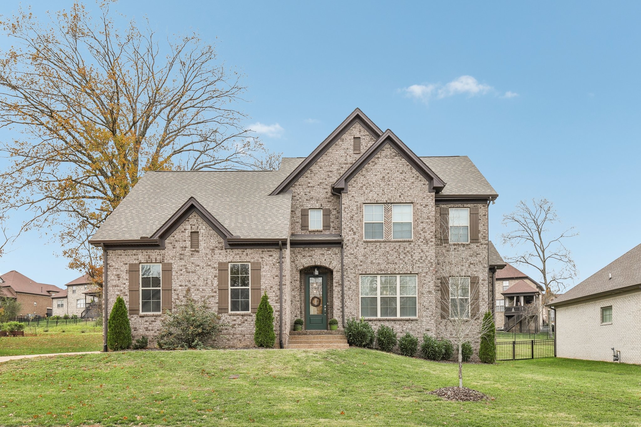 a front view of a house with a yard