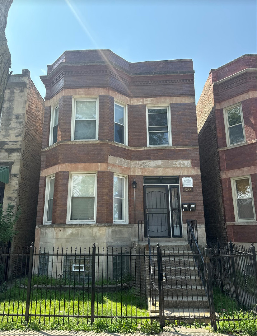 a front view of a house with large windows