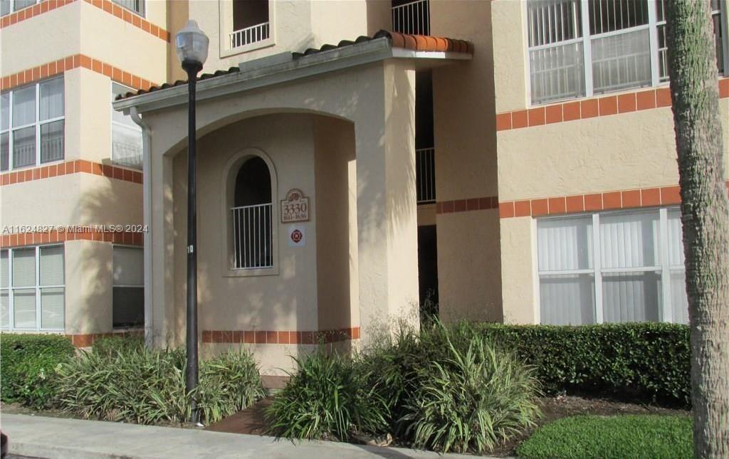 a front view of a house with plants