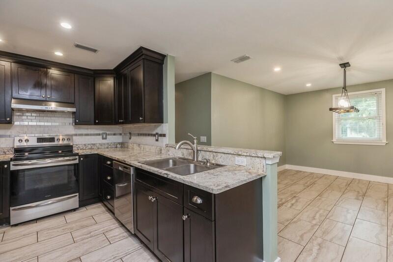 a kitchen with a sink stove and cabinets