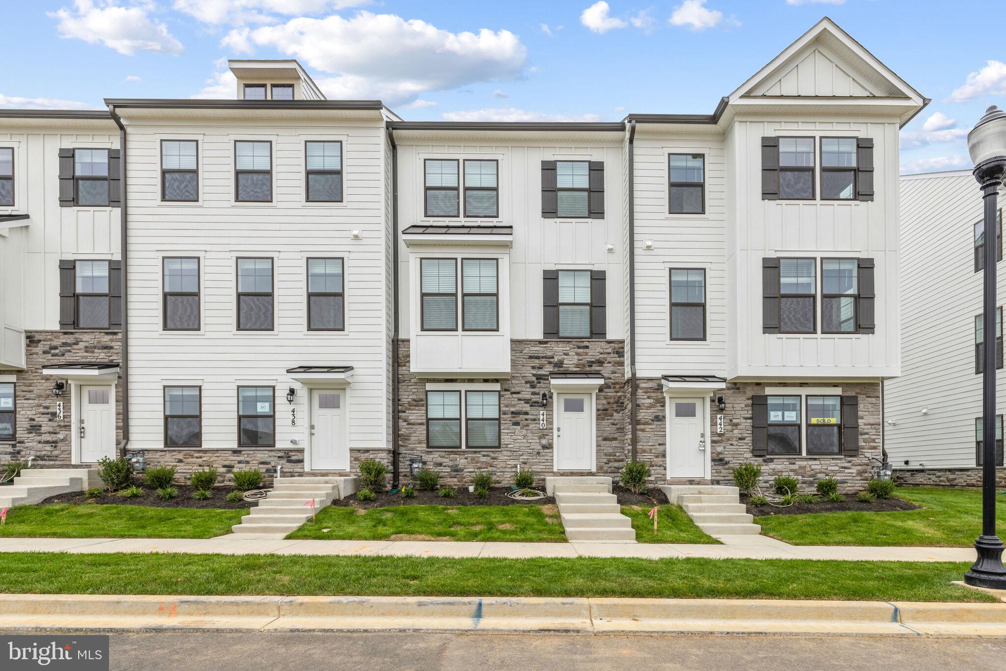 a front view of a residential apartment building with a yard