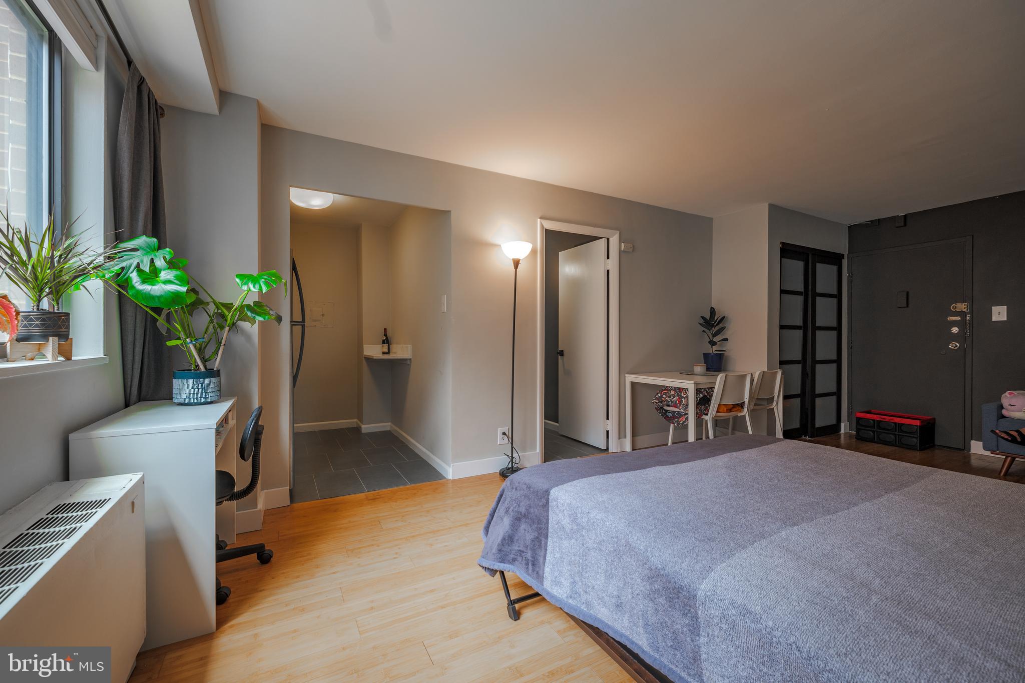 a bedroom with a bed and potted plant